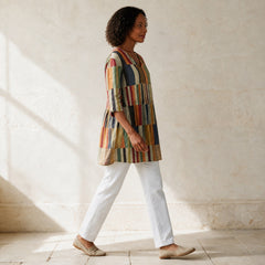 Chloe multicolour patchwork stripe tunic shown in side-profile movement