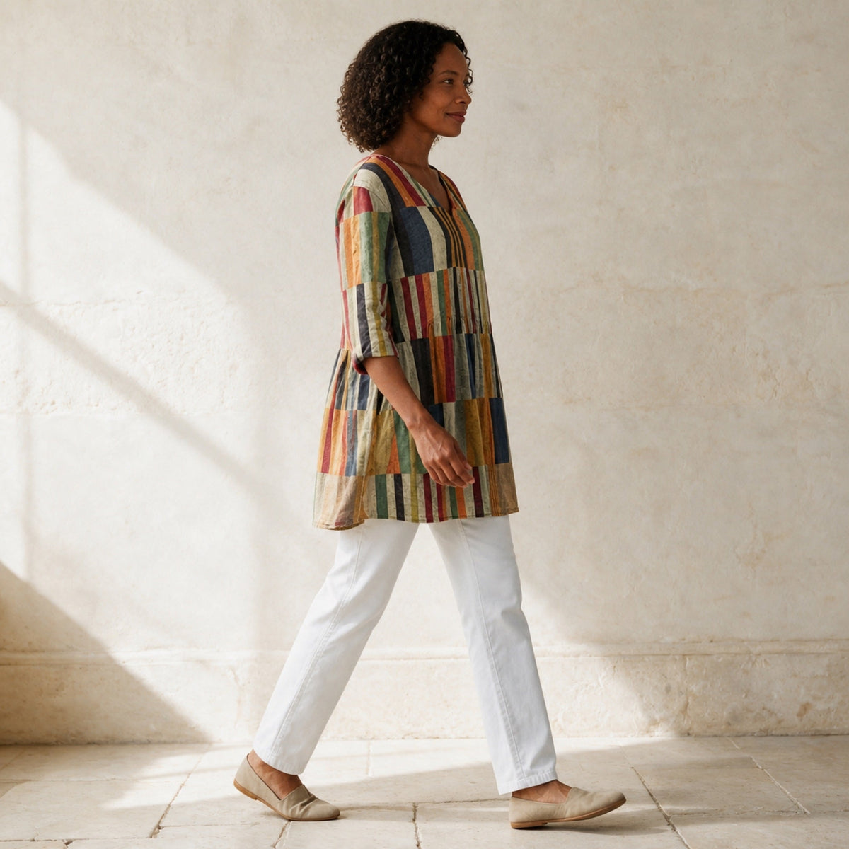Chloe multicolour patchwork stripe tunic shown in side-profile movement