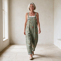 Woman walking in sage green floral printed dungarees
