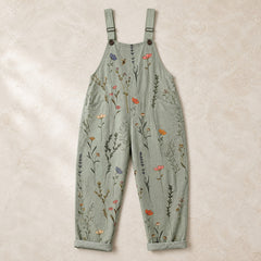 Sage green floral printed dungarees arranged in a clean flat lay