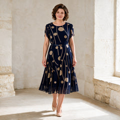 IVY navy chiffon midi dress in a gentle walking pose