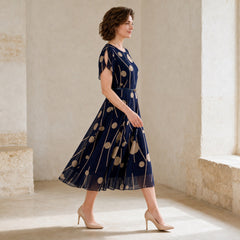 IVY navy and beige chiffon midi dress shown in side-profile movement