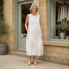 Helen wearing the beige LUNA RETRO CASUAL DRESS, contextual full-body view outside the Cotswold stone boutique.