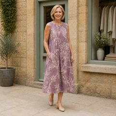 Helen wearing the multicolour Mia Floral Midi Dress, three-quarter full-body view outside the Cotswold stone boutique.