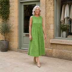 Sara midi dress in Green — walking view on Rose outside the Cotswold boutique