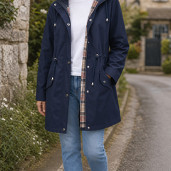 The Hadley rain jacket in navy, styled on a Cotswold village lane