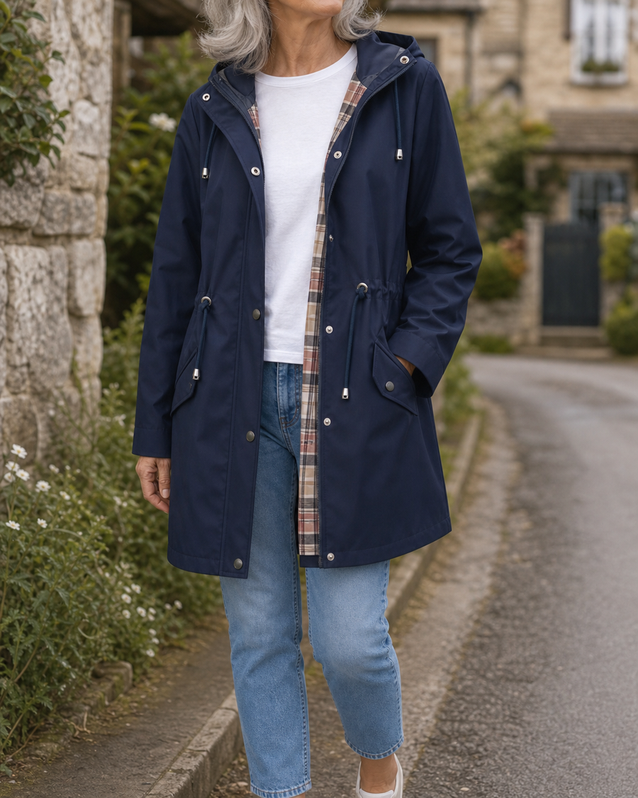 The Hadley rain jacket in navy, styled on a Cotswold village lane