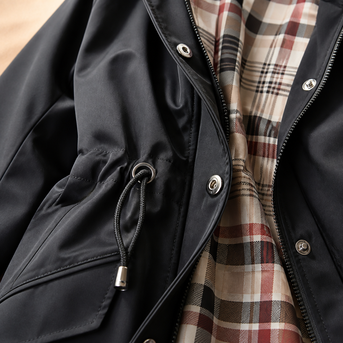 Close-up of The Hadley jacket's plaid lining and waist drawstring