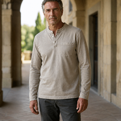 Light khaki Saltwater long-sleeve Henley worn in a Cotswold arcade