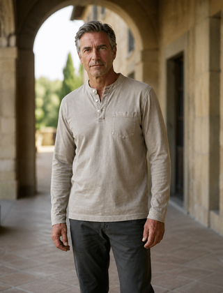 Light khaki Saltwater long-sleeve Henley worn in a Cotswold arcade