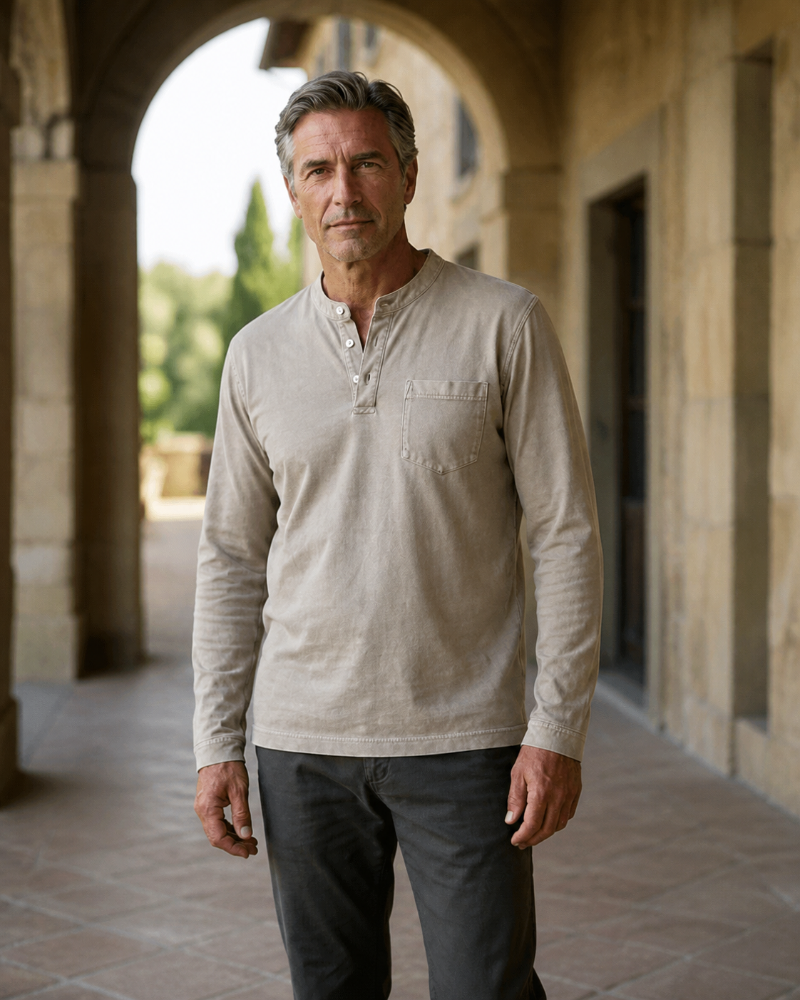 Light khaki Saltwater long-sleeve Henley worn in a Cotswold arcade